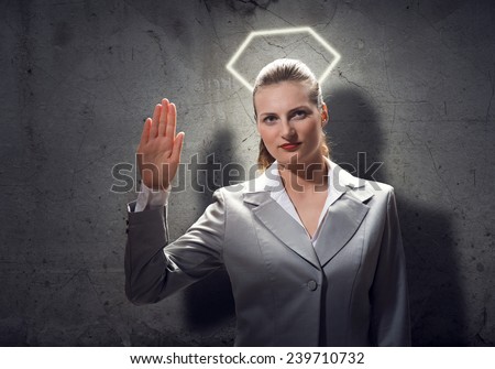 Young saint businesswoman with halo above head