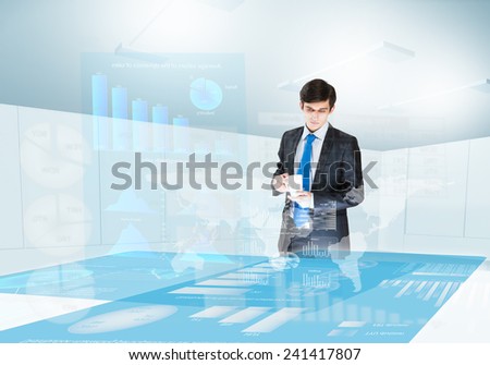 Young businesswoman looking at digital screen with market data