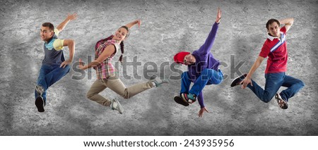 Group of dancer in jump on cement background