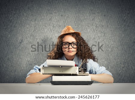 Young pretty girl writer using typing machine