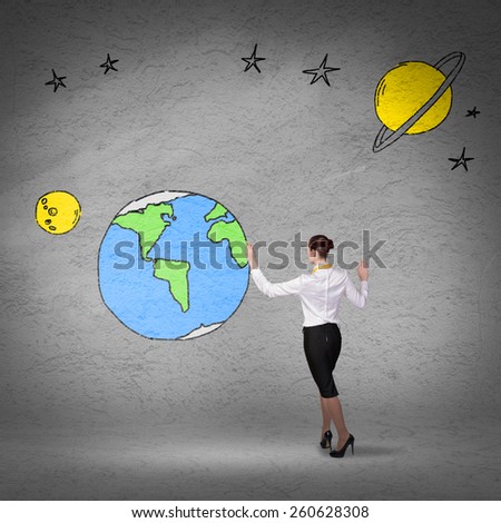Rear view of businesswoman presenting drawn Earth planet