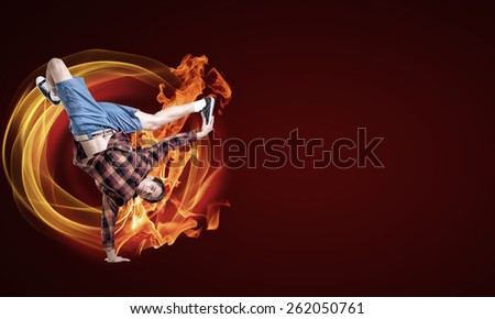 Modern style dancer in jump and lights at background