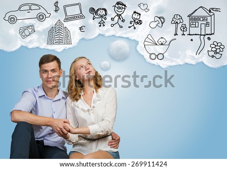 Young happy family couple dreaming of future wealthy life