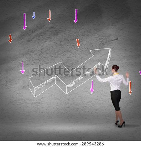 Rear view of businesswoman drawing increasing graph