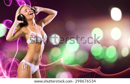 Attractive girl in white bikini and headphones on color background