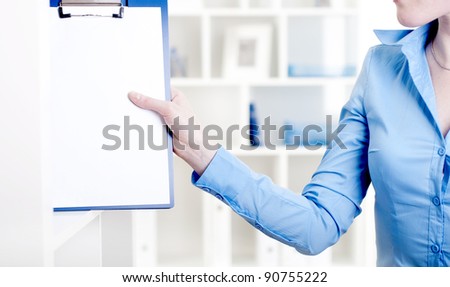 woman puts a tablet with documents in a rack for documents
