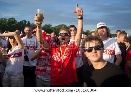 KRAKOW,POLAND-JUNE 8: Polish fans follow their team in the opening match of eurocup 2012 against greece in fanzone,on 8th june,2012 in Krakow,Poland