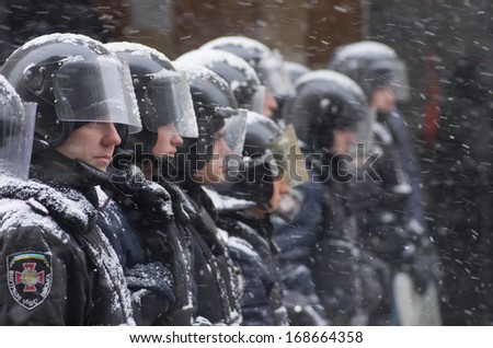 KIEV, UKRAINE - DECEMBER 11: police men defend the presidential palace as the protest continues despite the heavy snowstorm  on December 11, 2013 in Kiev, Ukraine