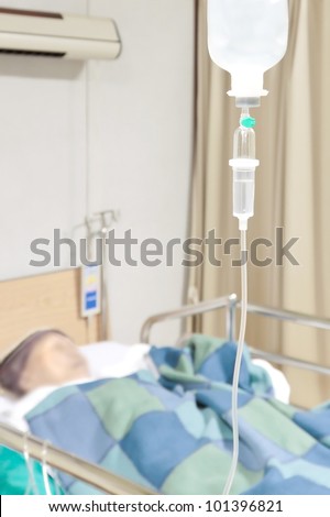Senior woman patient in the hospital bed saline intravenous (iv) drip