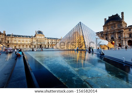 PARIS -AUG 5, 2013      Louvre museum at twilight in summer  AUG 5, 2013 in Paris, France. Louvre Museum is one of the world\'s largest museums, every year museum visits more than 8 million visitors.