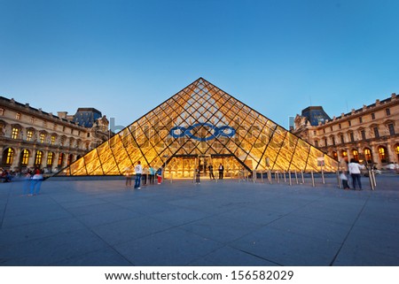 PARIS -AUG 5, 2013      Louvre museum at twilight in summer  AUG 5, 2013 in Paris, France. Louvre Museum is one of the world's largest museums, every year museum visits more than 8 million visitors.