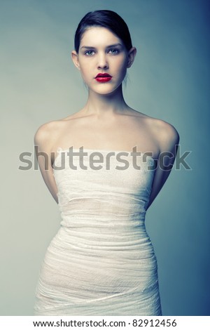 Portrait of a young girl wrapped in bandages with big red lips
