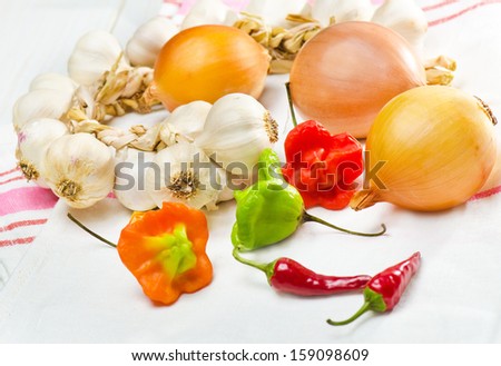 still life of garlic onion pepper and spice isolated on white background