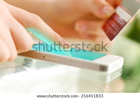 Woman is shopping online with cell phone.