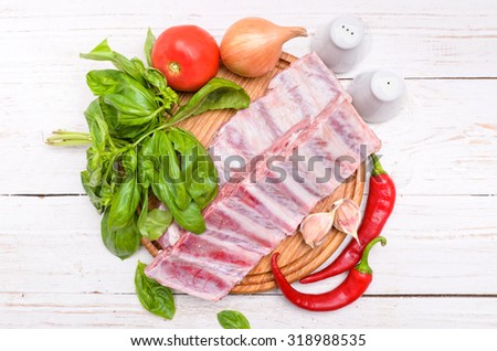 Raw pork rib meat on wooden board.