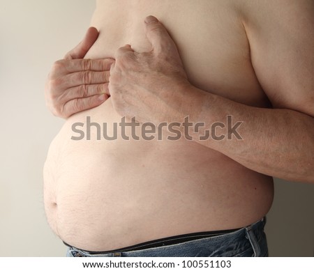 shirtless, overweight man with heartburn or possibly more serious chest pain