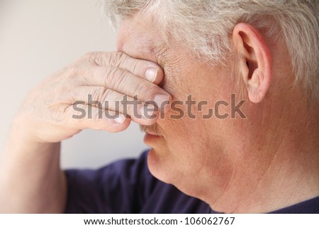 an older man covers his eyes as he is overcome with emotions