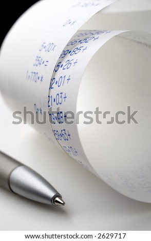 Closeup image of adding machine tape with pen.