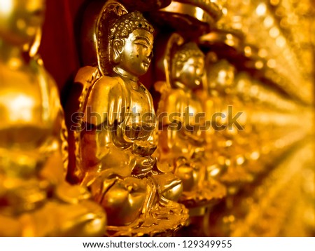 gold buddha statue on wall  in church at chinese temple in Thailand