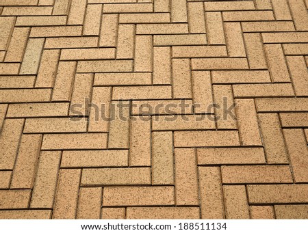 Herringbone structure of the tile pavement is photographed closely.