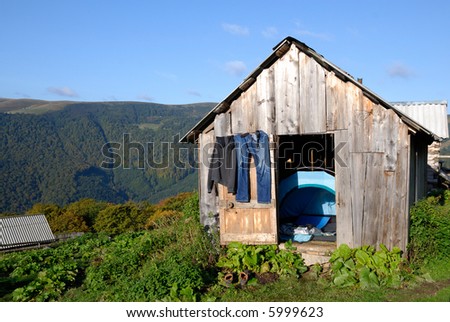 Beautiful landscape in green Carpathian mountains with hills. House of hiker