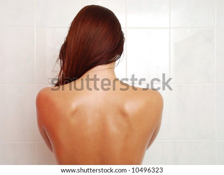 Wet back naked of woman with long hair, shining skin with drops of water