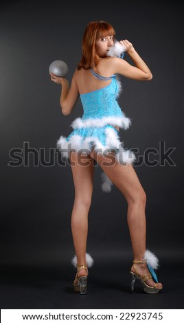 Semi-nude girl standing back and playing white down or silver ball, bright blue fancy dress decorated with white fluff