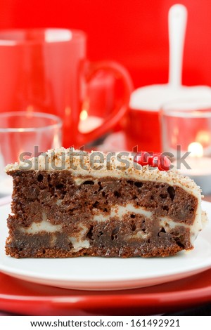 Cocolate cake with nuts on a red background. New Year's cake.