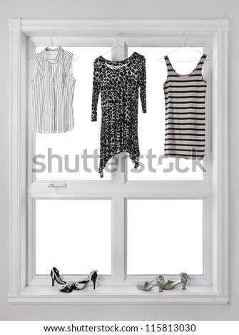 Black and white clothes hanging in the window.