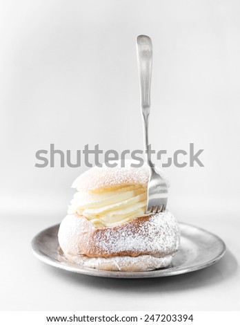 Semla cream bun on silver plate. Pastry typically eaten in Sweden in February.
