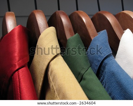 Colorful shirts on wooden hangers