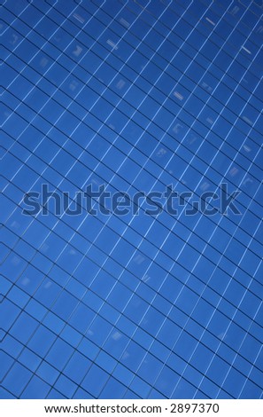 Blue windows background. Windows of a skyscraper, forming a pattern.