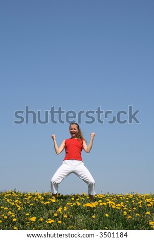 Sporty girl in a flowering field, yelling \