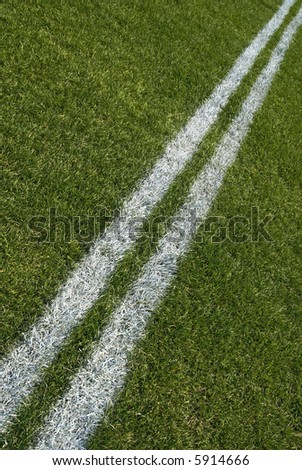 Boundary lines of a green playing field, diagonal.