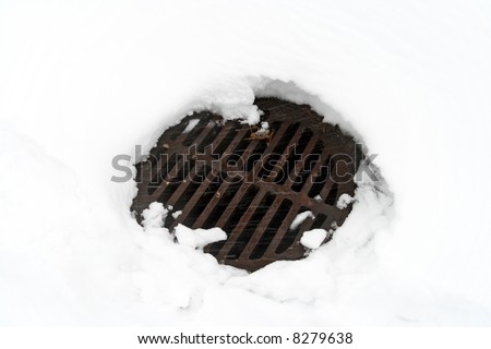 Snow melted around the drain manhole cover.