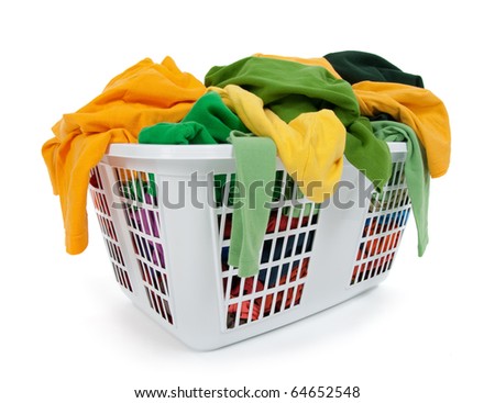 Bright clothes in a laundry basket on white background. Green, yellow.