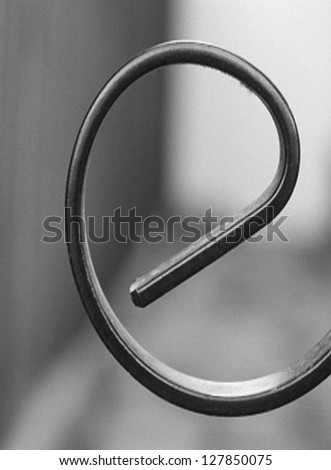 A metal image in black and white taken in a way to make it look like a letter e. The image was shot at day time with a ISO of 100 , shutter speed 1/80 and f stop of 5.6 to give  image a blurred look.