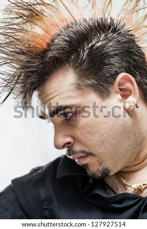 Young punk man profile showing mohawk hairdo on a white background