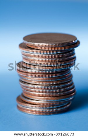 Stack of quarters on a blue background
