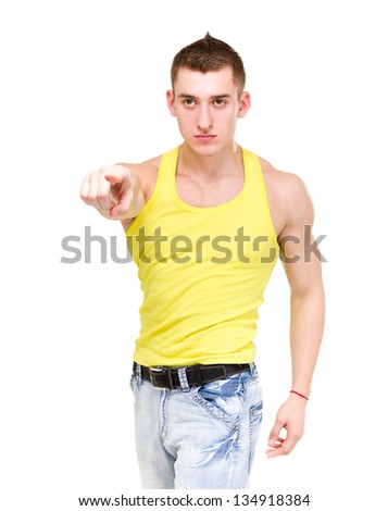 Young serious muscular man pointing at you, isolated on white background. fitness gym concept