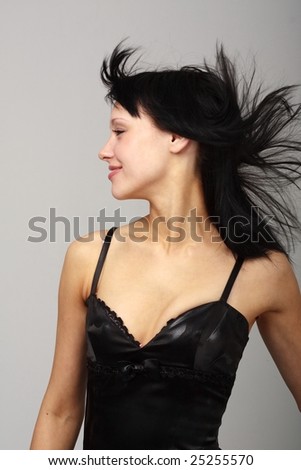 Wind. Attractive young woman with crazy hair close up.
