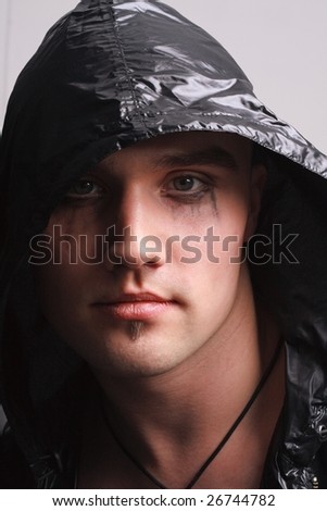 Portrait of a goth man on a grey background
