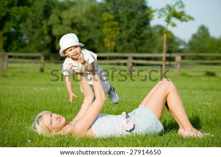 Mother with her child playing outside