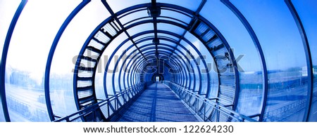 Interior blue glass tunnel, city public construction