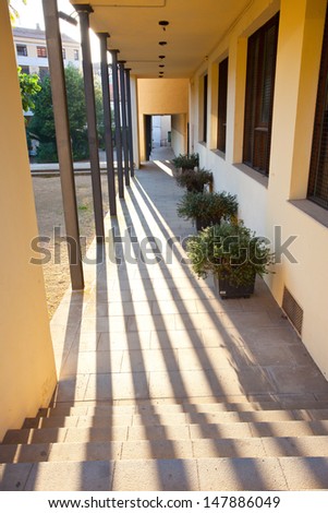 passage, gallery with metal columns and shadows