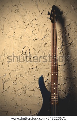 guitar stands near the gray wall, instagram image style