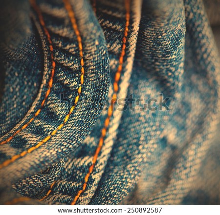 blue Jeans with yellow stitching thread close up, small depth sharpness. instagram image retro style