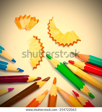 vintage colored pencils with chips on white background