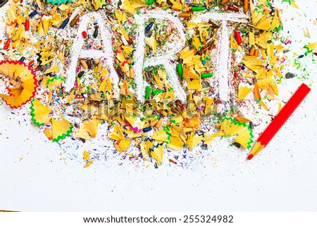 ART word on the background of colored pencil shavings on the white