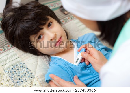 digital thermometer in the hands of a doctor. Temperature measurement in the child. home medicine. focus on thermometer
